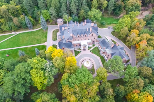 Castle in Moscow in the park. A modern Moscow castle surrounded by trees