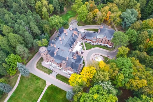 Castle in Moscow in the park. A modern Moscow castle surrounded by trees