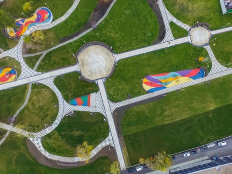 Paths in the park of paving slabs, top view of the city park