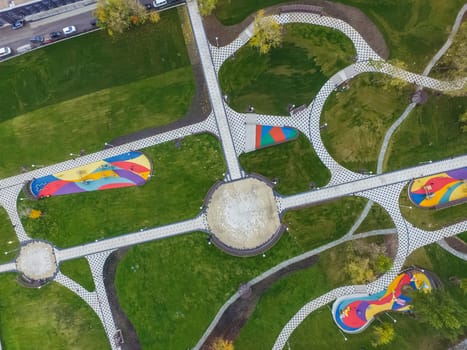 Paths in the park of paving slabs, top view of the city park