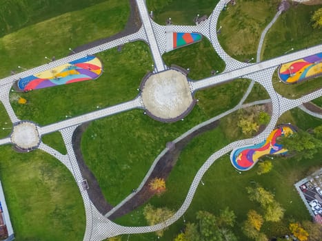 Paths in the park of paving slabs, top view of the city park