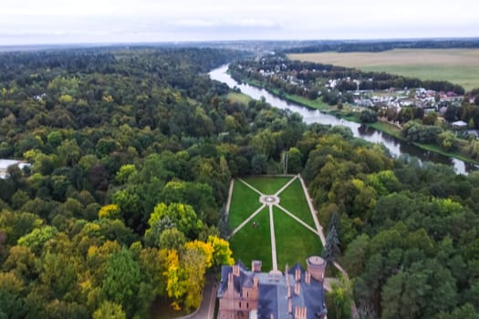 Castle in Moscow in the park. A modern Moscow castle surrounded by trees