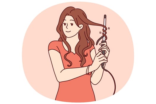 Woman uses electric curling iron to get curly hairstyle and get ready for party or date with boyfriend. Girl with curling iron wants to become beautiful giving straight hair curly look