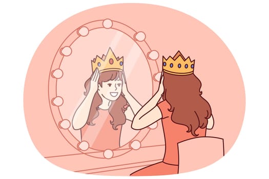 Little actress tries on crown sitting in dressing room with mirror and dreams of playing role of princess on theater stage. Teenage girl puts princess crown on head dreaming of living among kings