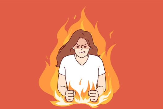 Nervous woman experiencing aggression due to psychological problems, standing in middle of burning flame. Girl aggression and disappointment are caused by bad character and defensiveness.