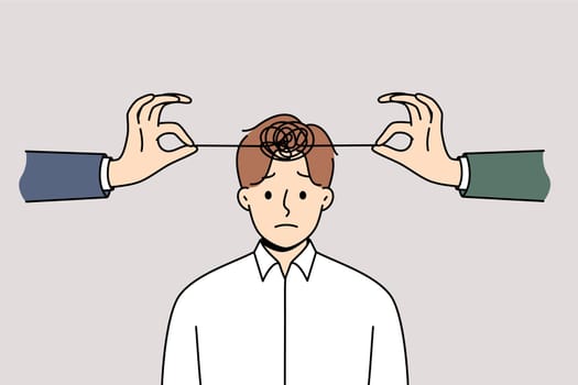 Problems with psychological health in man with tangled threads on head and hands of friends trying to untangle lump. Psychological disorder and insanity in business guy in need of psychotherapist