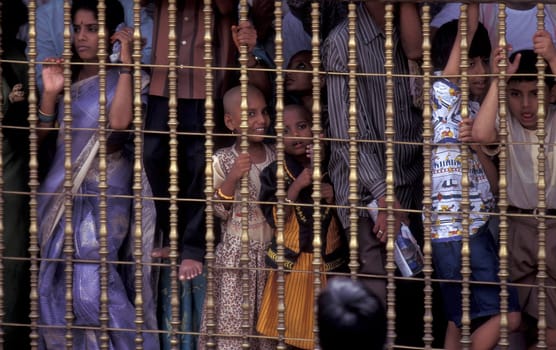 People stand in line at the entrance at the Meenakshi Amman Temple in the city of Madurai in the Province Tamil Nadu in India.  India, Madurai, April, 1998