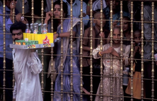 People stand in line at the entrance at the Meenakshi Amman Temple in the city of Madurai in the Province Tamil Nadu in India.  India, Madurai, April, 1998