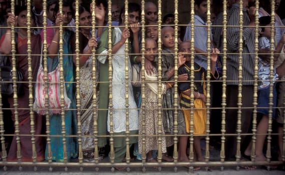 People stand in line at the entrance at the Meenakshi Amman Temple in the city of Madurai in the Province Tamil Nadu in India.  India, Madurai, April, 1998
