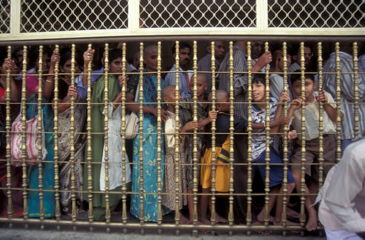 People stand in line at the entrance at the Meenakshi Amman Temple in the city of Madurai in the Province Tamil Nadu in India.  India, Madurai, April, 1998