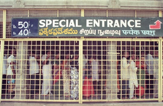 People stand in line at the entrance at the Meenakshi Amman Temple in the city of Madurai in the Province Tamil Nadu in India.  India, Madurai, April, 1998