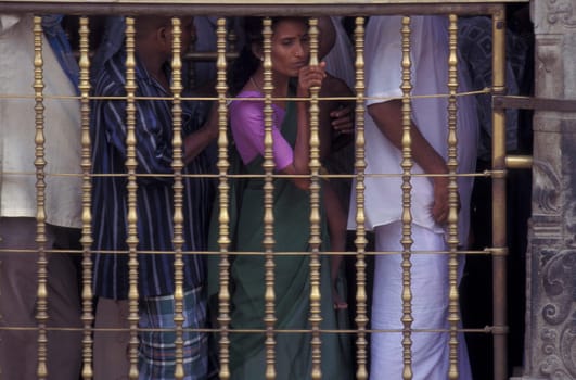 People stand in line at the entrance at the Meenakshi Amman Temple in the city of Madurai in the Province Tamil Nadu in India.  India, Madurai, April, 1998