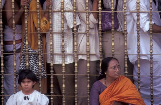 People stand in line at the entrance at the Meenakshi Amman Temple in the city of Madurai in the Province Tamil Nadu in India.  India, Madurai, April, 1998