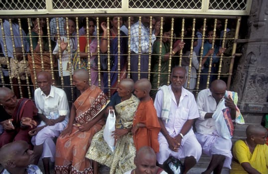 People stand in line at the entrance at the Meenakshi Amman Temple in the city of Madurai in the Province Tamil Nadu in India.  India, Madurai, April, 1998