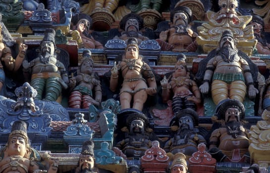 Hindu carving figures at a Tower of the Meenakshi Amman Temple in the city of Madurai in the Province Tamil Nadu in India.  India, Madurai, April, 1998