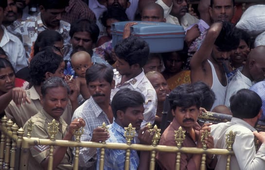 People stand in line at the entrance at the Meenakshi Amman Temple in the city of Madurai in the Province Tamil Nadu in India.  India, Madurai, April, 1998