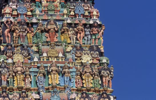 Hindu carving figures at a Tower of the Meenakshi Amman Temple in the city of Madurai in the Province Tamil Nadu in India.  India, Madurai, April, 1998