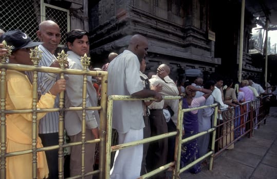 People stand in line at the entrance at the Meenakshi Amman Temple in the city of Madurai in the Province Tamil Nadu in India.  India, Madurai, April, 1998