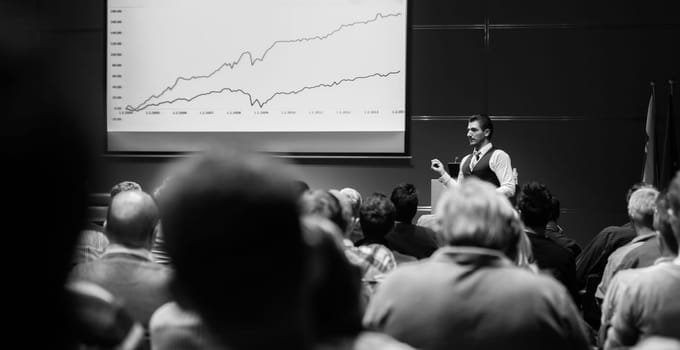 Speaker Giving a Talk at Business Meeting. Audience in the conference hall. Business and Entrepreneurship concept. Black and white.