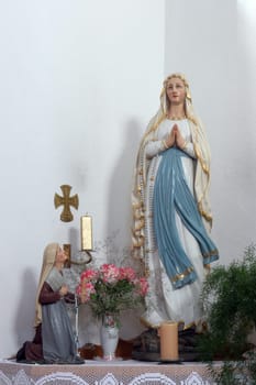 Our Lady of Lourdes, statue in the Parish church of Saint Bartholomew in Hrastovica, Croatia