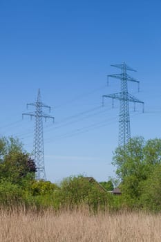 Electricity pylons on the River Este, Buxtehude, Lower Saxony, Germany