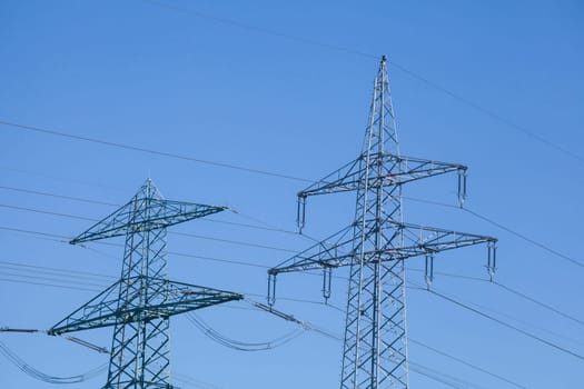 Electricity pylons on the River Este, Buxtehude, Lower Saxony, Germany