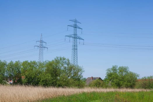 Electricity pylons on the River Este, Buxtehude, Lower Saxony, Germany