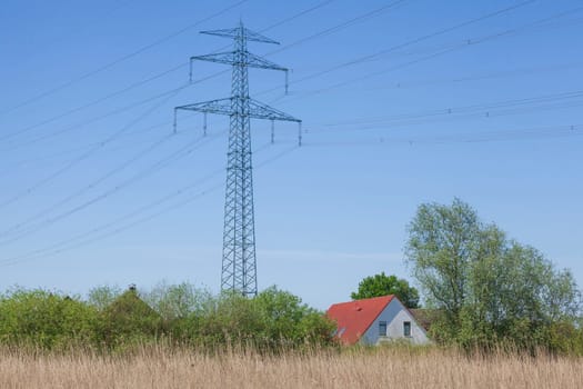 Residential building with electricity pylons on the River Este, Buxtehude, Lower Saxony, Germany