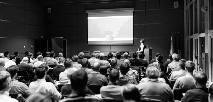 Speaker Giving a Talk at Business Meeting. Audience in the conference hall. Business and Entrepreneurship concept. Black and white.