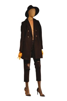 Full length female mannequin wearing ripped dark mid-length trousers, a jacket over a shirt, a hat and high heel shoes. Clipping path. Woman with casual fashion. Mannequin