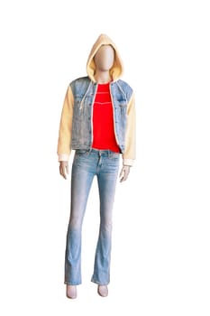 Full length male mannequin dressed in jeans, jeans jacket and a bright hoody over red shirt isolated on white background. Clipping path.