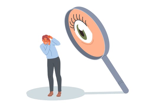 Man is afraid of surveillance and pressure from giant eye in magnifying glass, causing stress and discomfort. Concept of pressure on employee from annoying boss who does not trust company staff