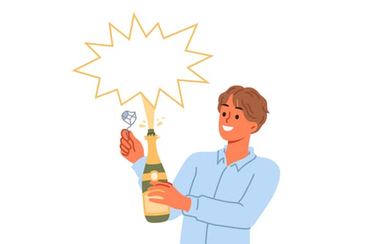 Man opens champagne and sees splash of alcoholic drink during festive christmas party. Bottle of champagne or sparkling wine in hands of waiter or bartender looking at copy space with smile