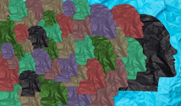 Multi-colored silhouettes of heads cut out of crumpled paper, superimposed on each other, collective consciousness or exchange of ideas in a community