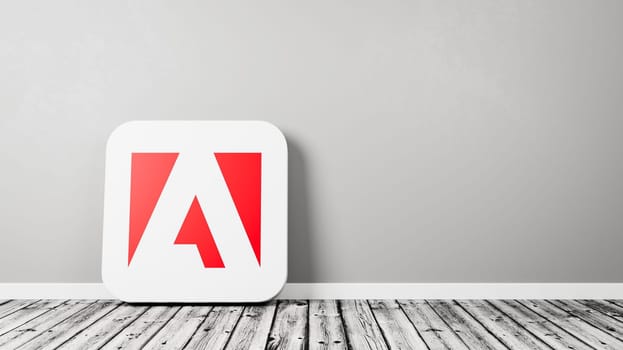 Adobe Inc. App Icon 3D Symbol Shape on Wooden Floor Against Gray Wall with Copy Space 3D Render Illustration