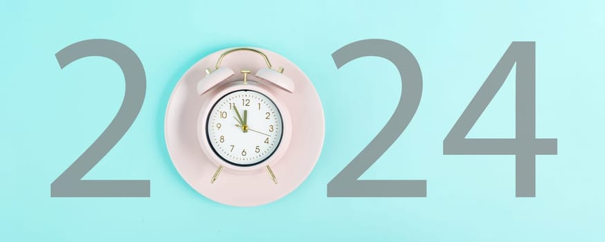 New year 2024 is loading, calendar date on an alarm clock, end of the year, changing time