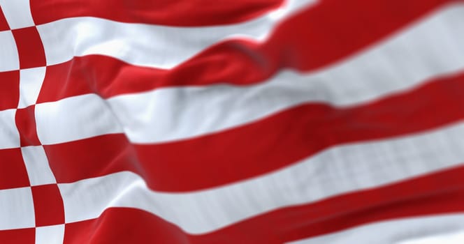 The civil flag of Bremen waving in the wind. Eight red and white stripes, bordered at the hoist by two vertical red-white chequered stripes. 3d illustration render. Selective focus. Close-up