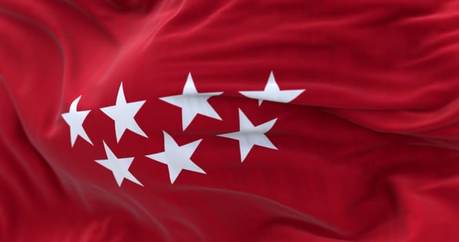 Detail of the Community of Madrid flag waving in the wind. Crimson red with seven silver five-pointed stars. 3d illustration render. Selective focus. Fluttering fabric