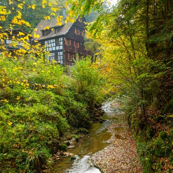 Watermill Klingenmühle at the river wieslauf in Germany autumn