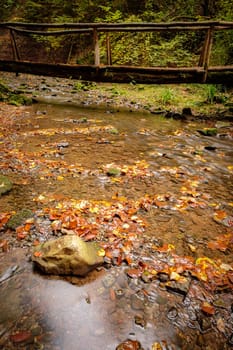 River Wieslauf with wooden bridge in fall landscape