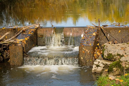 Build structure waterfall in autumn water reflection