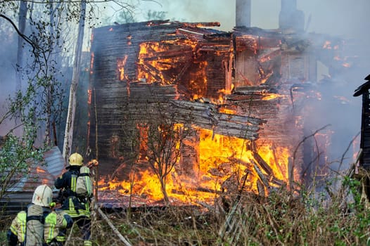 extinguishing the fire of a wooden house. High quality photo