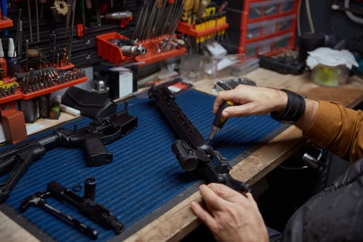 Man putting gun with ammunition in safety case top view closeup. Weapon merchandise at professional shop store