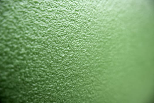 Detail of green rough background with texture, decorated wall