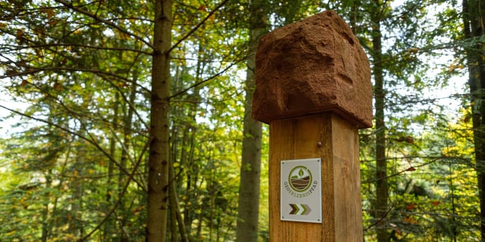 Sign of geology path in german forest landscape