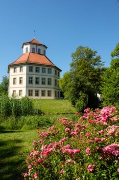 City hall building with meadow and red roses flower landmark