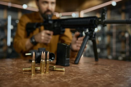 Closeup automatic rifle and bullets at weapon store. Production and sale of firearms for army and police special forces