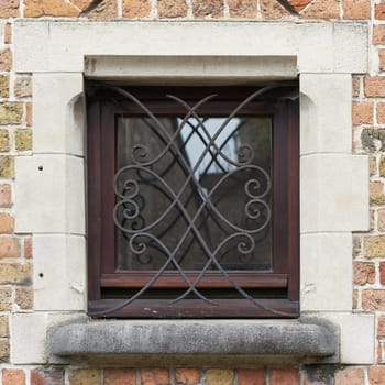 Window of a historic house with window grille in the old town of Bruges in Belgium