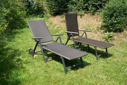 two sun loungers to relax on a meadow in the garden