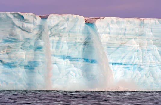 Twin Waterfalls on a Melting Tidal Glacier on Nordaustlandet Island in the Svalbard Islands